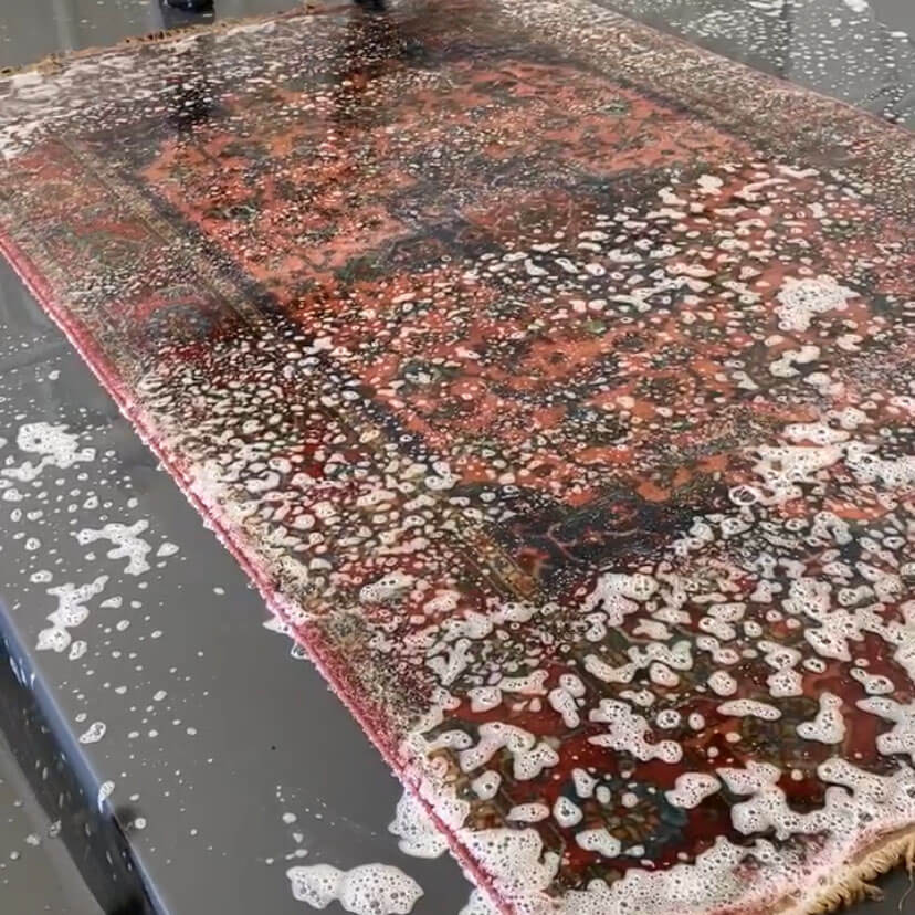 Rug with soap suds during wash process