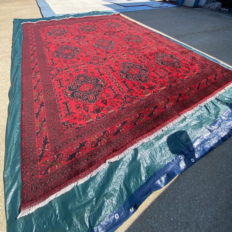 Red oriental area rug on wash pit floor